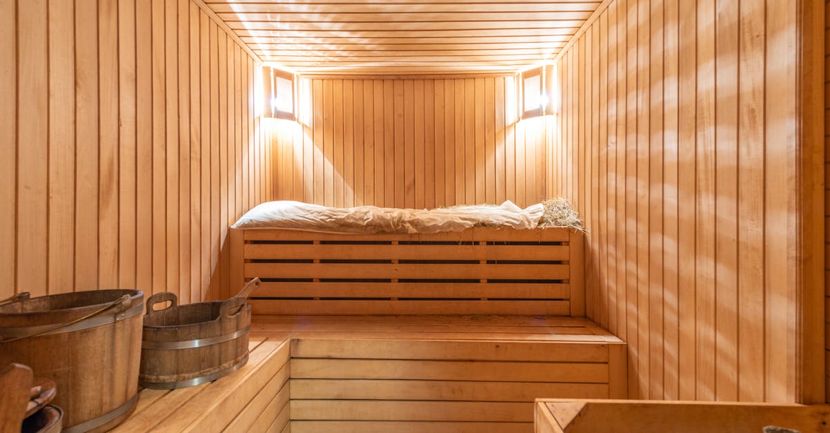 Warm and inviting wooden sauna with ambient lighting, perfect for relaxation.